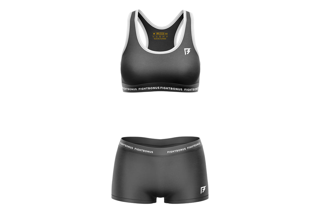 Black sports bra and shorts set with brand logo on a white background
